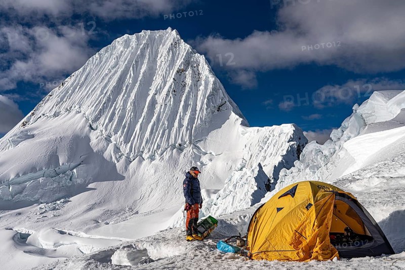 High camp with tent and mountaineer, tent camp, high camp at 5500 m above Alpamayao, southwest face, 5947 m, with the title of most beautiful mountain in the world, Cordillera Blanca, Huascaran National Park, northern Peru, Peru, South America