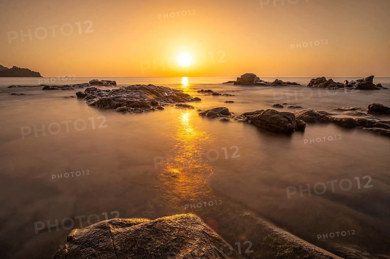 The sun rises on the horizon over the sea in Sardinia, Sardinia Italy