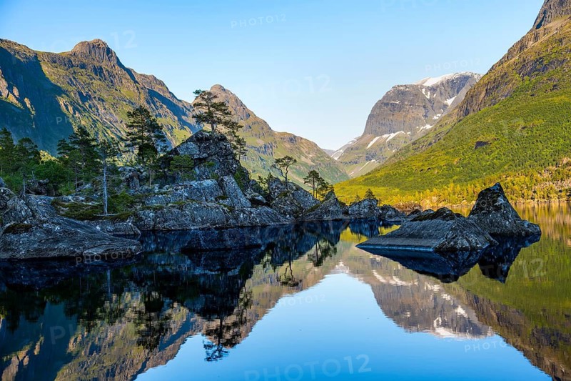Picturesque mountain landscape in the Innerdalen high valley, mountain peaks are reflected in Lake Innerdalsvatna, Trollheimen Mountain Area, Sunndal, Møre og Romsdal, Norway