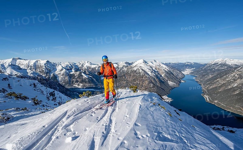 Picturesque view of Achensee and wintry mountain scenery, ski tourers at the summit of Bärenkopf, Achensee, Tyrol, Austria