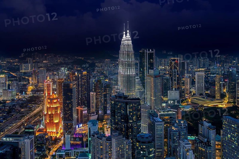 Petronas Towers, KLCC Twin Towers, interlinked 88-storey supertall twin skyscrapers illuminated at night in capital city Kuala Lumpur, Malaysia
