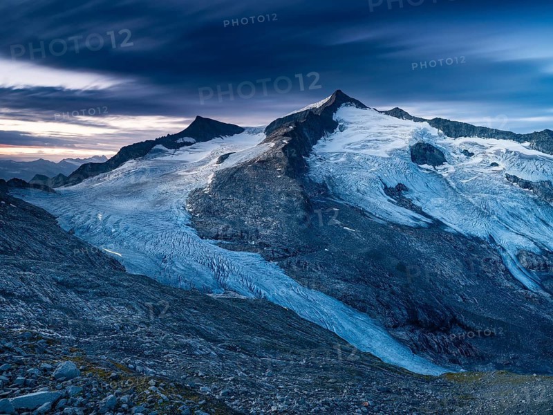 Glaciated summit of Grossvenediger, at dawn, on the Venedigerkees Traces of light from mountaineers, Venice Group, Hohe Tauern National Park, Province of Salzburg, Austria
