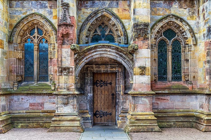 Used as a film set for The Da Vinci Code, a carved Gothic doorway and tracery windows form the south porch of 15th century Rosslyn Chapel, Roslin, Midlothian, Scotland, United Kingdom