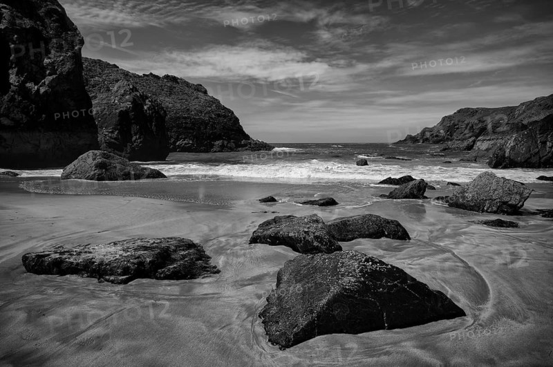 Wet rocks at low tide in sand, coastal landscape, coast, rock formations, sandy beach, beach, sea, Kynance Cove, Mount's Bay, Lizard Peninsula, peninsula, black and white, Cornwall, England, Great Britain, Great Britain