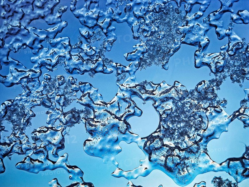 Abstract texture, close-up of ice crystals and frost structures on a glass pane, frozen skylight in winter, blue sky, light blue, macro, filling the format, Höxter, Germany