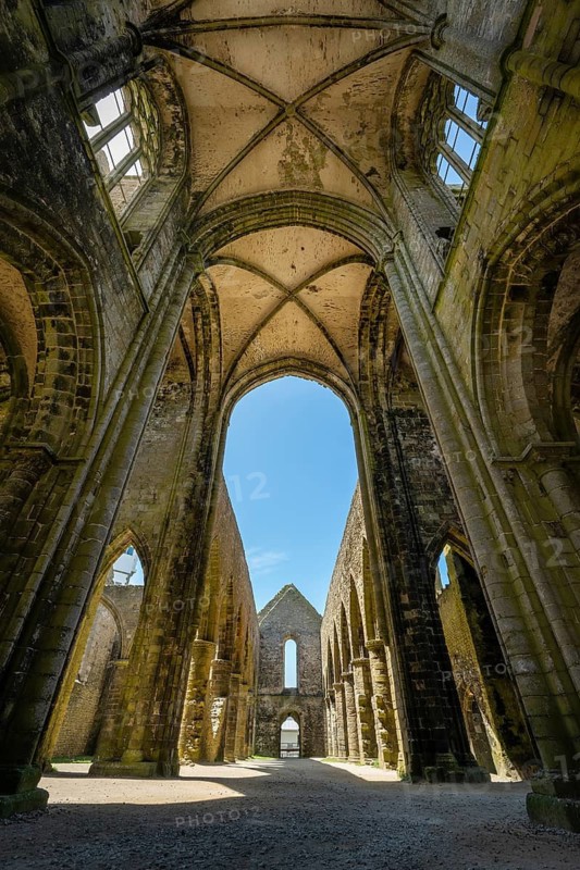 Looking up into the stone cross-rib vault of a Gothic church ruin looking at the sky through the window openings in Pointe Saint-Mathieu, Plougonvelin, Finistère department, Brittany, France