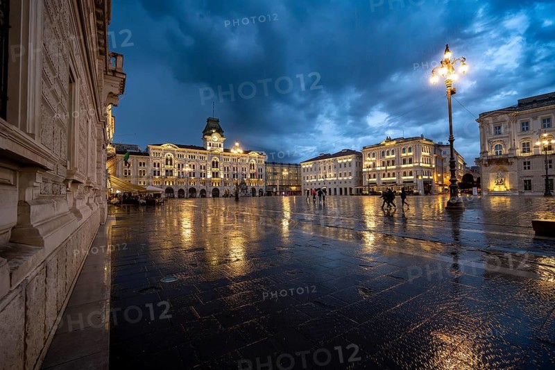 Illuminated square Piazza Unità d'Italia, Town Hall, Palazzo Communale, with reflection, dramatic clouds, blue hour, old town, Trieste, Friuli-Venezia Giulia region, Italy