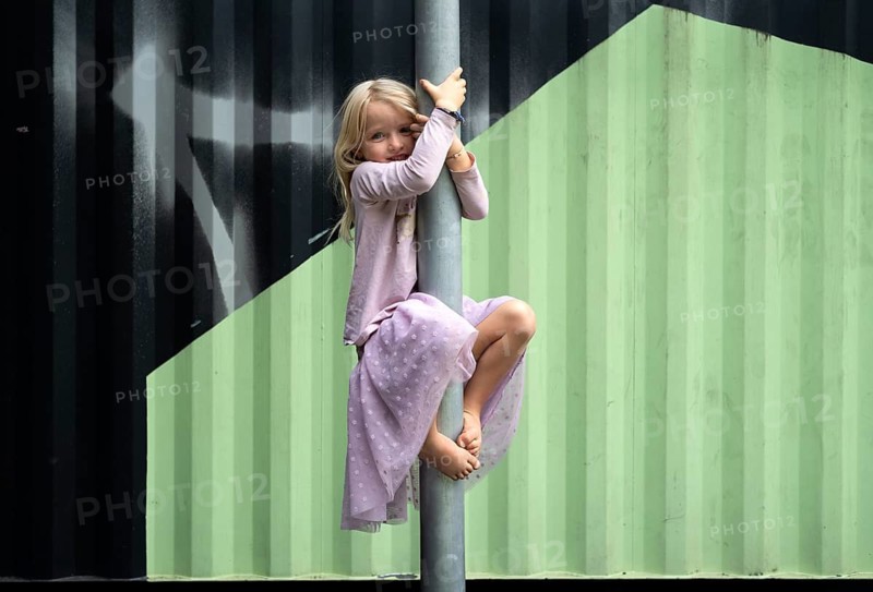 Girl, blonde, 5 years old, dress, gymnastics on climbing pole, climbing frame, smiles, playground, Stuttgart, Baden-Württemberg, Germany