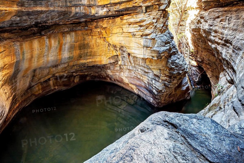 A bay-like formation with calm water surrounded by tall, winding rocks, deep gorge in the spiny savanna of Caatinga in the federal states of Pernambuco and Bahia in Brazil