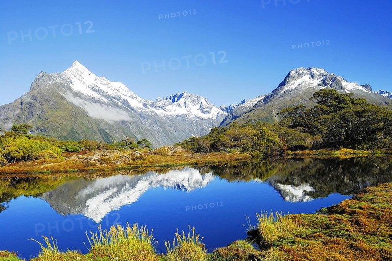 Key Summit with reflection of Mt. Christina, Fjordland National Park, World Heritage Site South West New Zealand, West Coast, South Island of New Zealand