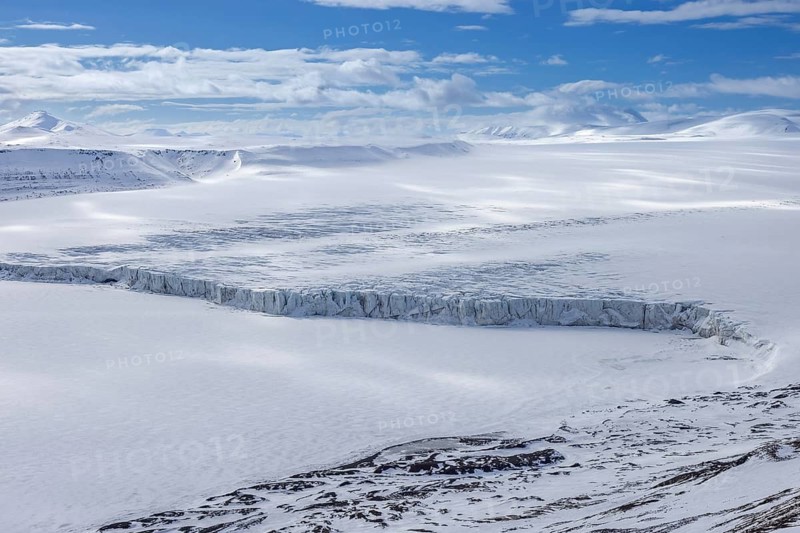 View over Ulvebreen, glacier in Sabine Land debouching into the bay of Dunérbukta on western shore of Storfjorden in spring, Spitsbergen, Svalbard
