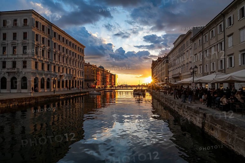 Grand Canal with restaurants, reflection in the canal, sunlight, evening light at sunset, dramatic clouds and atmospheric lighting, Borgo Teresiano, Trieste, Friuli-Venezia Giulia region, Italy