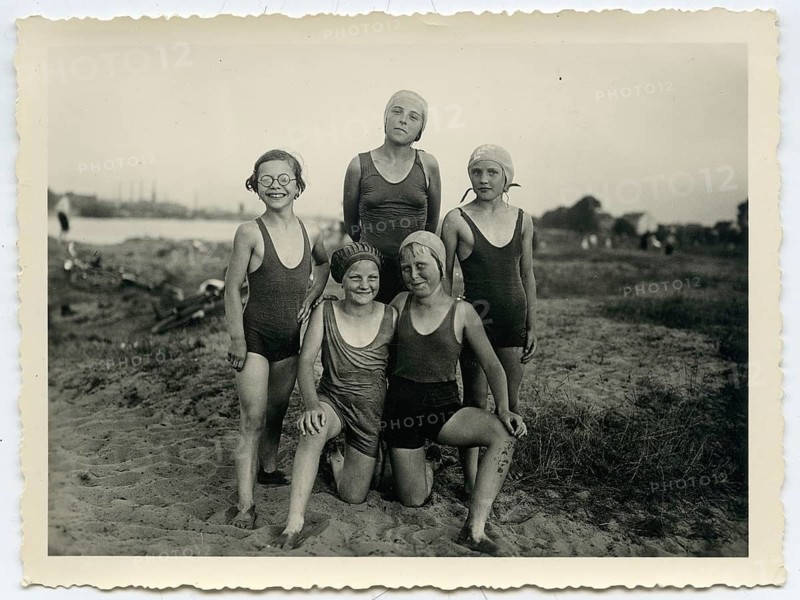 Swimwear, Five girls in bathing suits pose happily together on the beach, Bremen, Weser, 1936