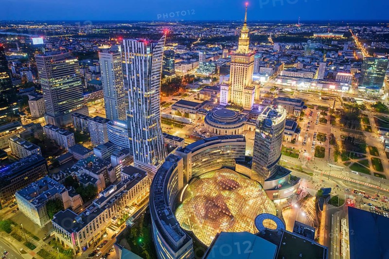 Urban skyline view of Warsaw, Poland, with the Palace of Culture landmark, skyline, broad city view, blue hour twilight and city lights