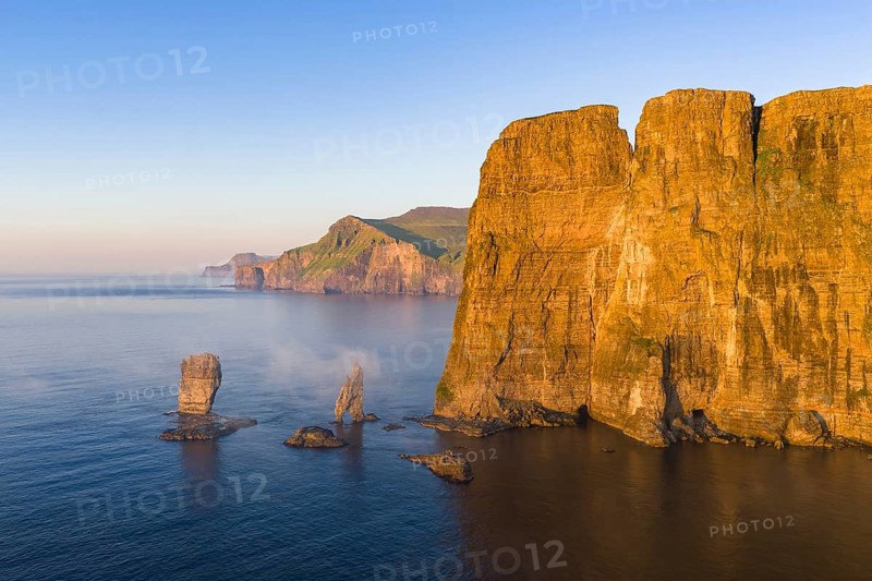 The Risin og Kellingin pinnacles off the Eysturoy cliffs in the evening light, Faroe Islands, Denmark