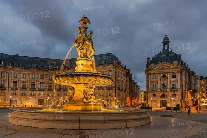 Illuminated fountain of the Three Graces on Place de la Bourse, Bordeaux, Gironde, France