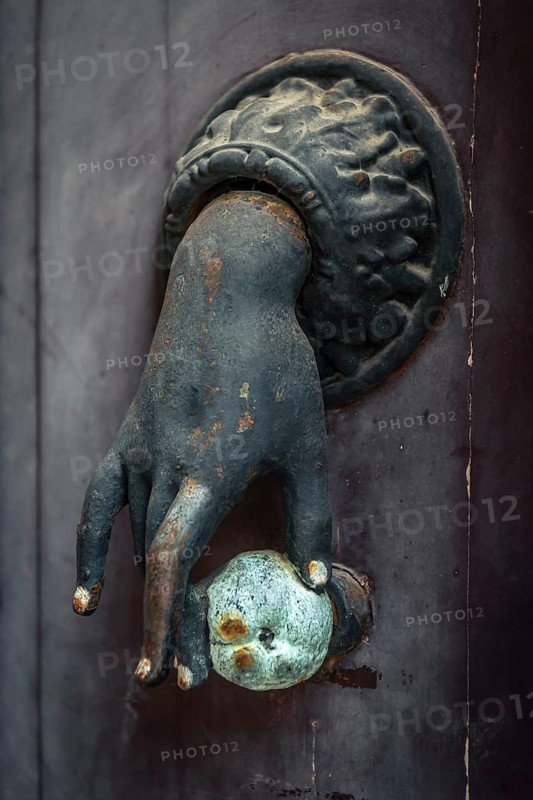 Old French door knocker with hand and apple on front door in Pèrigueux, Dordogne, France