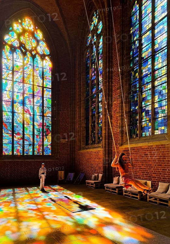 Sky swing in the town church of Our Dear Women, installation by Mario Haunhorst with stained glass windows by Alfred Manessier with the title Blessed swing, believe, hope, love at your own risk, Bremen, Germany