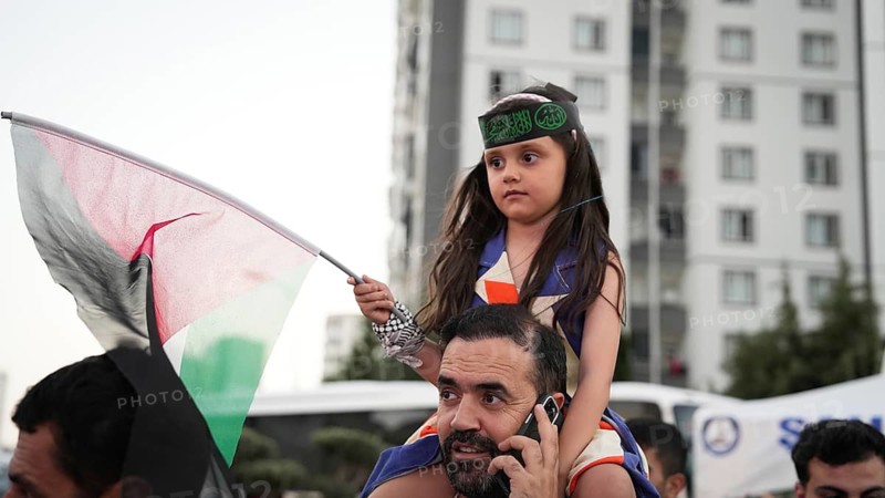 Gaziantep, Turkey - August 06, 2026: Participants of the Palestine Convoy, which set off from Sarajevo, Bosnia and Herzegovina, gather alongside local residents in Gaziantep while waving Palestinian flags to draw global attention to ongoing Israeli attacks on Gaza and the humanitarian crisis in Palestine, Gaziantep, Turkey
