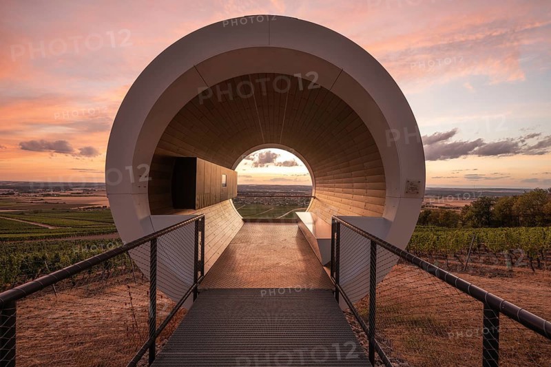 20 August 2026, View of the modern terroir f pavilion overlooking vineyard landscapes at sunset in Rödelsee, Bavaria, Germany