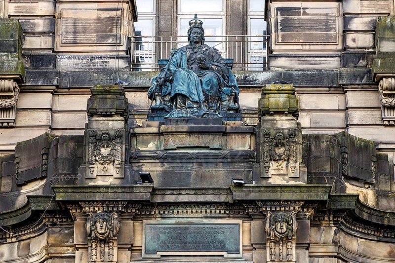 Enthroned bronze Queen Victoria statue crowns the Glasgow Royal Infirmary Jubilee block entrance, Glasgow, Scotland, United Kingdom