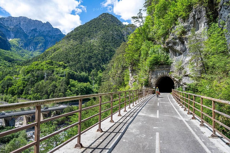 Cyclists with panniers on a cycle path with tunnel, cycle path along the old Pontebba railway line in Eisental, mountain landscape of the Julian Alps, Alpe-Adriatic cycle path, bike packing, Friuli-Venezia Giulia, Italy