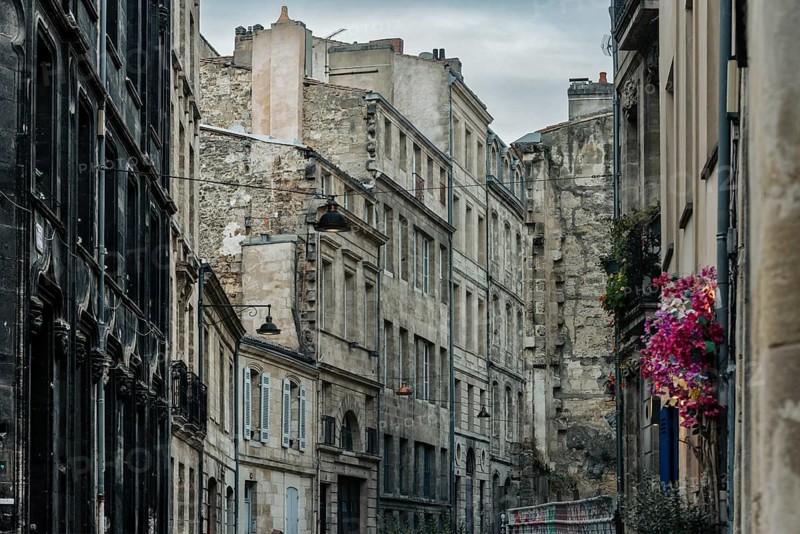 Dilapidated old town with floral decoration in Bordeaux, Gironde, France