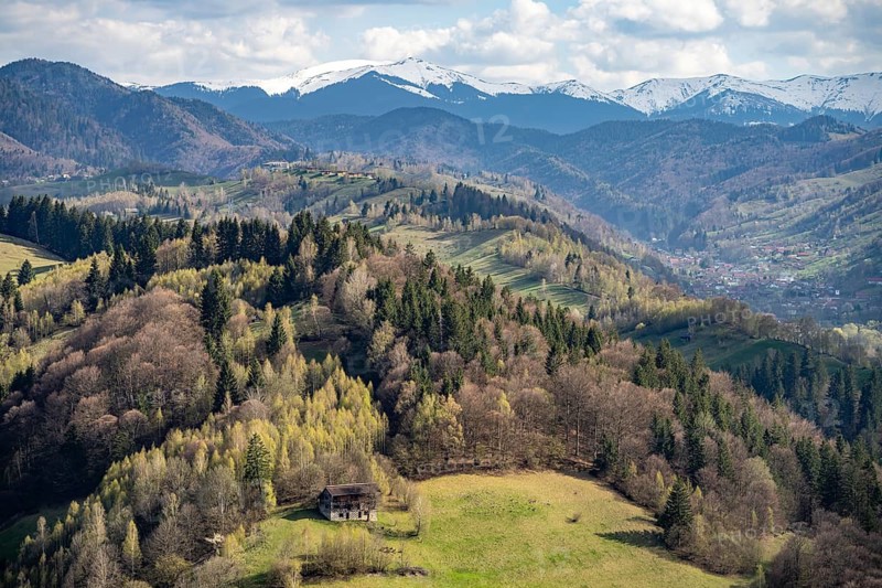 The snow-capped Bucegi Mountains and the countryside near Bran or Törzburg, Transylvania, Romania