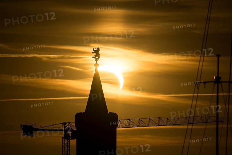 Shortly in front of sunset, the sun darkens during a solar eclipse, seen here with the Warsaw Bridge in Berlin Friedrichshain on 12/08/2026