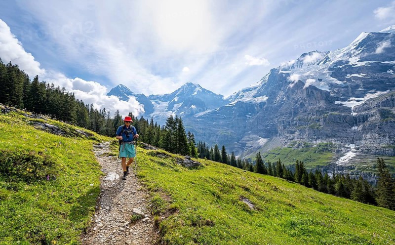 Hikers on a hiking trail on Mettlenalp, mountain panorama with peaks Eiger, Mönch and Jungfrau, Bernese Alps, Bernese Oberland, Switzerland