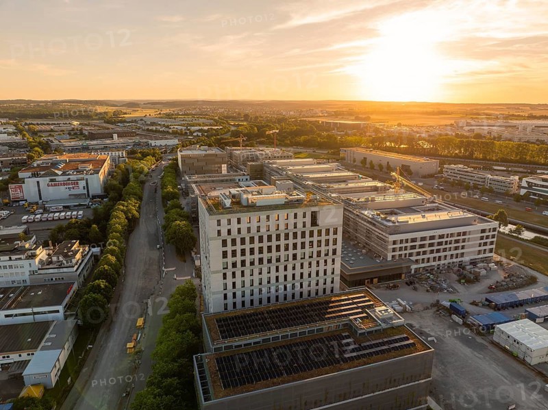 Urban industrial area with roads and buildings at sunset, construction site of the new airfield clinic, Böblingen, Germany