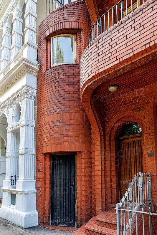Secret London, Close view of the curved red brick facade of London's smallest house at 10 Hyde Park Place, London, United Kingdom
