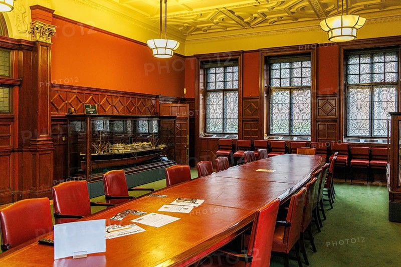 Ornate Victorian boardroom with long table, ship model and stained glass windows at the former Fairfield shipyard offices in Govan, Glasgow, Scotland, United Kingdom