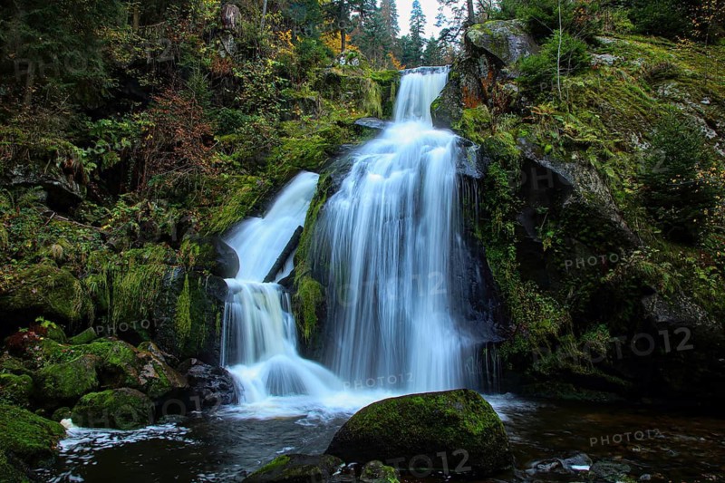 Long-exposure waterfalls flowing over mossy rocks in the forest, upper part of the Triberger Wasserfall, Black Forest-Baarkreis, Baden-Württemberg, Germany