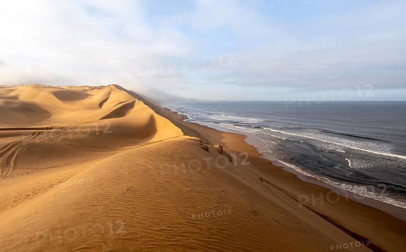 Sand dunes and sea, Atlantic coast and sandy desert with sea of dunes, Sandwich Harbour, Namib Naukluft Park, Namib Desert, Namibia