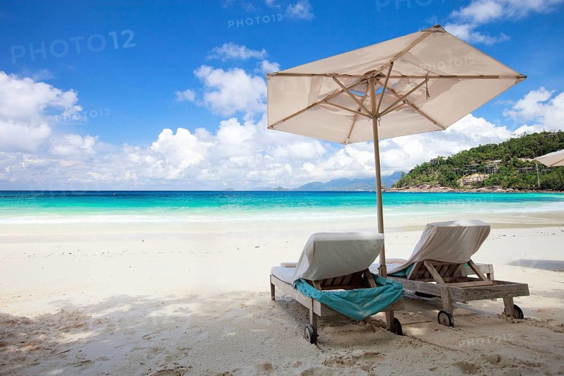 Two sun loungers and an sunshade on La Digue beach, Seychelles, La Digue, Indian Ocean, Seychelles