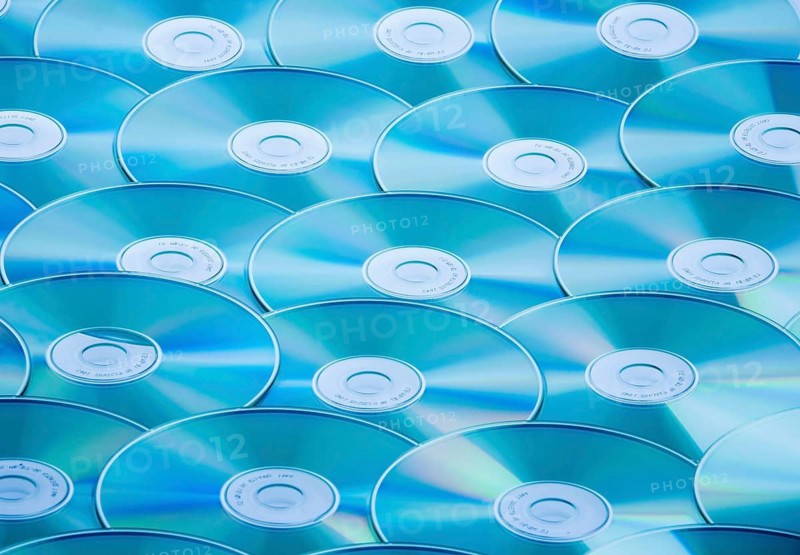A table full of CD-ROM and DVD, pirated copy, studio recording, Austria