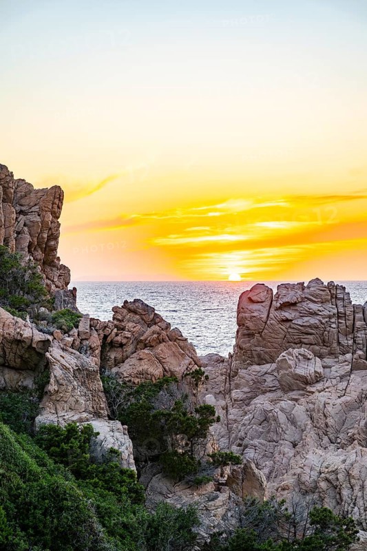 Landscape of the coastline with blue water at Costa Paradiso on a sunny day at sunset, Sardinia, Italy