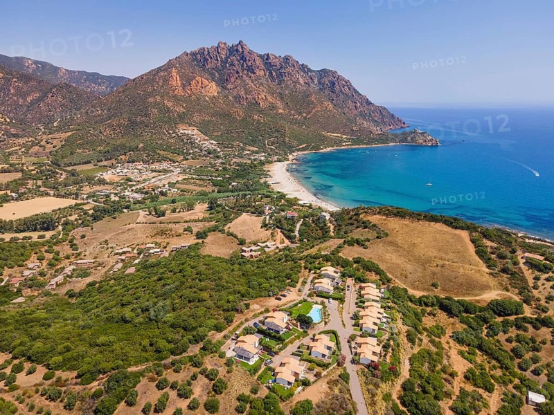 A cloudless blue sky shines over Foxi Manna beach, renowned throughout Europe, in the municipality of Tertenia on the island of Sardinia, Italy. (Aerial view taken by drone), Foxi Manna, Tertenia, Sardinia, Italy