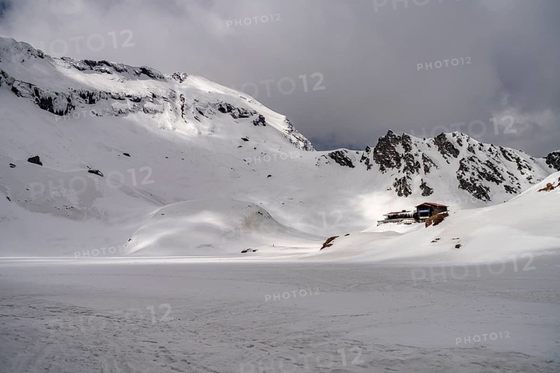 The snowy glacial lake Balea Lake in the Fagaras Mountains, South Carpathians, Transylvania, Romania