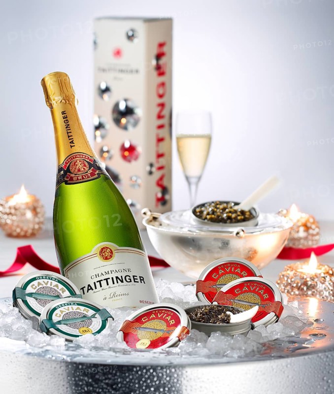 Champagne and caviar finely decorated on ice, studio shot