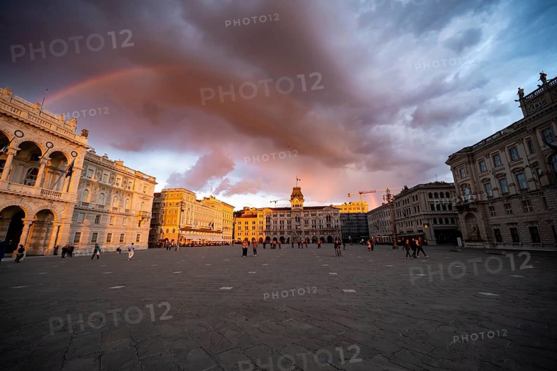 Piazza Unità d'Italia square with town hall and magnificent palazzi in the evening light at sunset with rainbow, dramatic clouds, old town, Trieste, Friuli-Venezia Giulia region, Italy