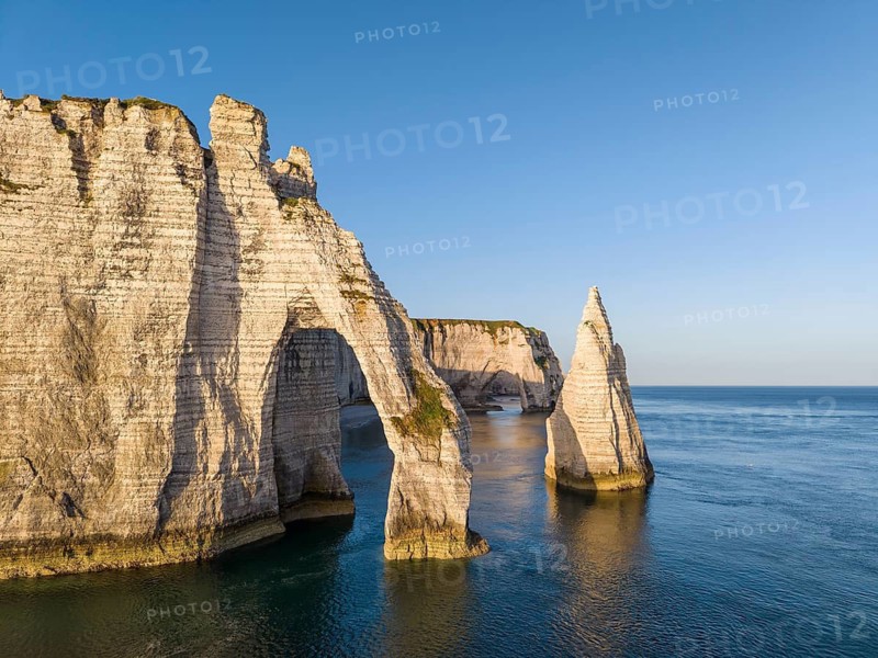 Aerial view of the Porte d'Aval rock formation shortly after sunrise, well-known landmark on the chalk coast with the distinctive Aiguille d'Étretat rock pin, behind it the La Manneporte rock gate, Étretat, Alabaster Coast, La Côte d'Albâtre, chalk cliffs, English Channel, Seine-Maritime, Normandy, France
