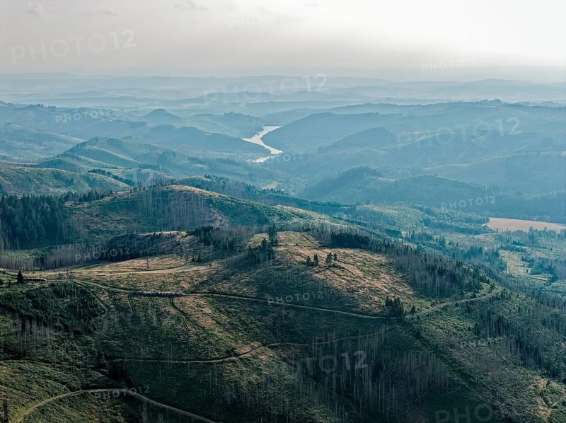 Mountain landscape in the Harz nature park Park, evening haze over the valleys, and in the Sösestausee valley. aerial view. Harz, Landkreis Goslar, Lower Saxony, Germany
