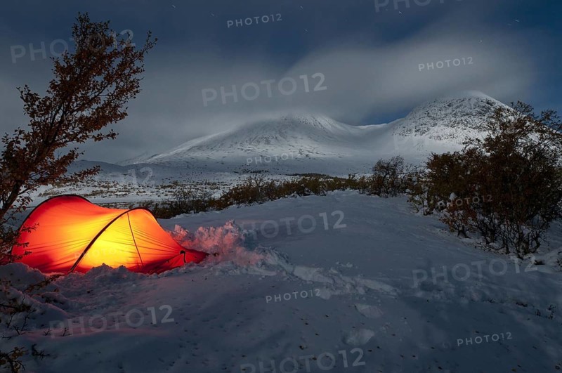 Bivouac, illuminated tent on a bright moonlit night in the Döralen valley, Rondane National Park, Oppland Fylke, Norway