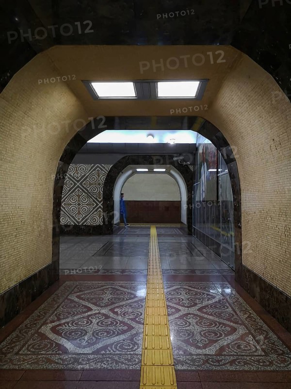 ALMATY, KAZAKHSTAN, NOVEMBER 8, 2019: Almaty Station of Almaty Subway, Kazakhstan, A subway station featuring archways, intricate tile designs, and a yellow tactile path under bright lighting, Almaty, Kazakhstan