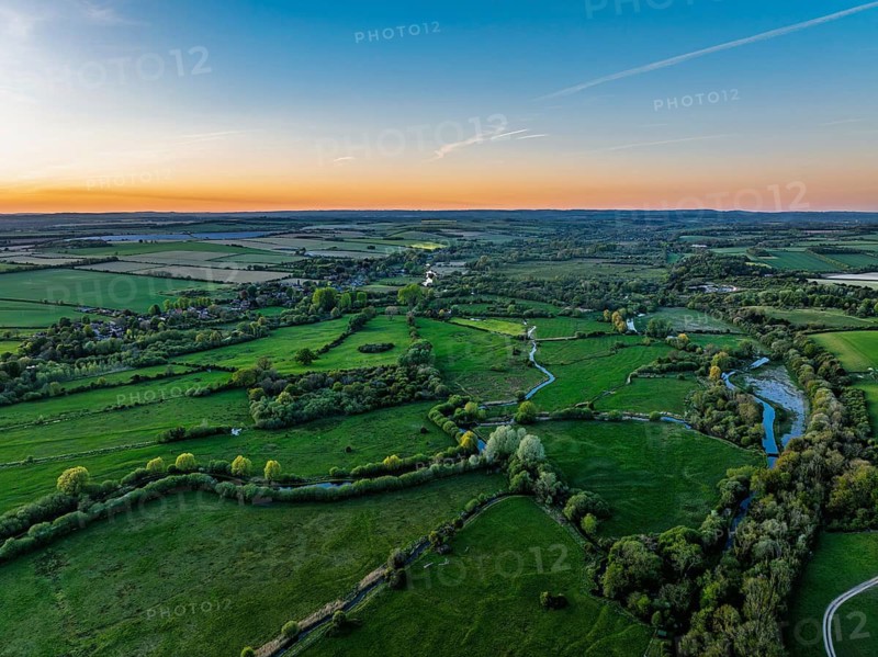 Sunset of Fields and Farms over Horsebridge nad Stockbridge from a drone, Hampshire, England, United Kingdom