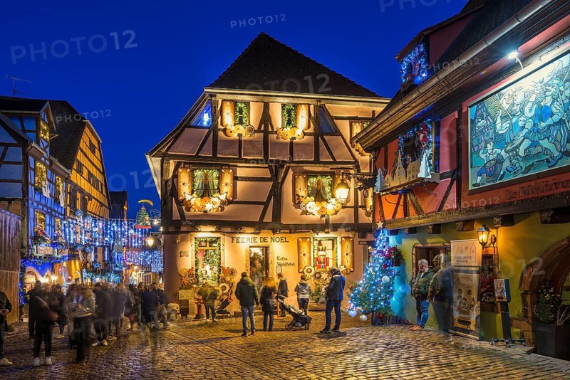Colour-illuminated and Christmassy decorated half-timbered houses, blue hour, Christmas market, Riquewihr, Grand Est, Haut-Rhin, Alsace, France