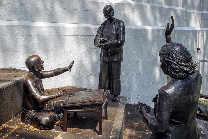 A Great Emporium bronze sculpture depicting coolies and traders by Malcolm Koh's recreates weighing of goods during Singapore's early trading days, Boat Quay Singapore