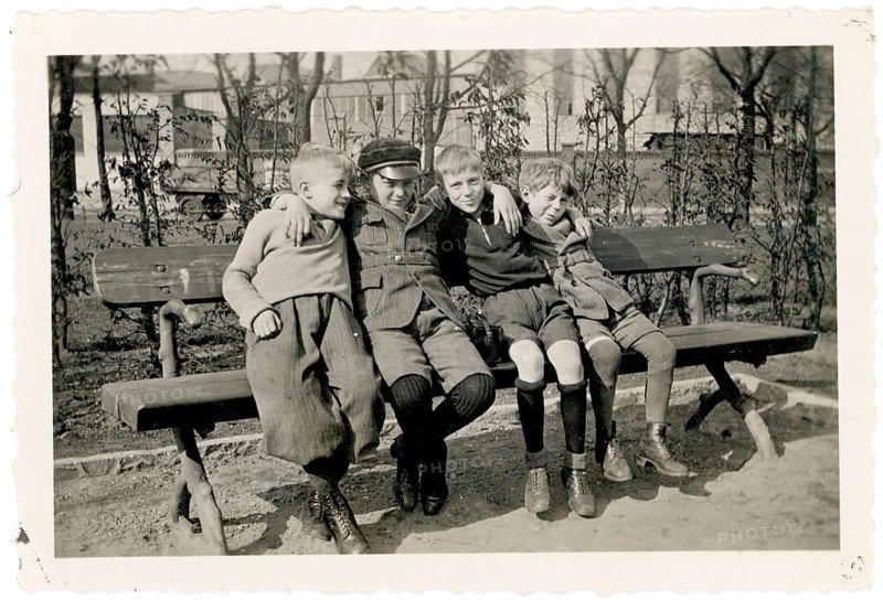 Friends, children, gang, rascal, four boys sitting together on a park bench, cheerful scene, around 1928